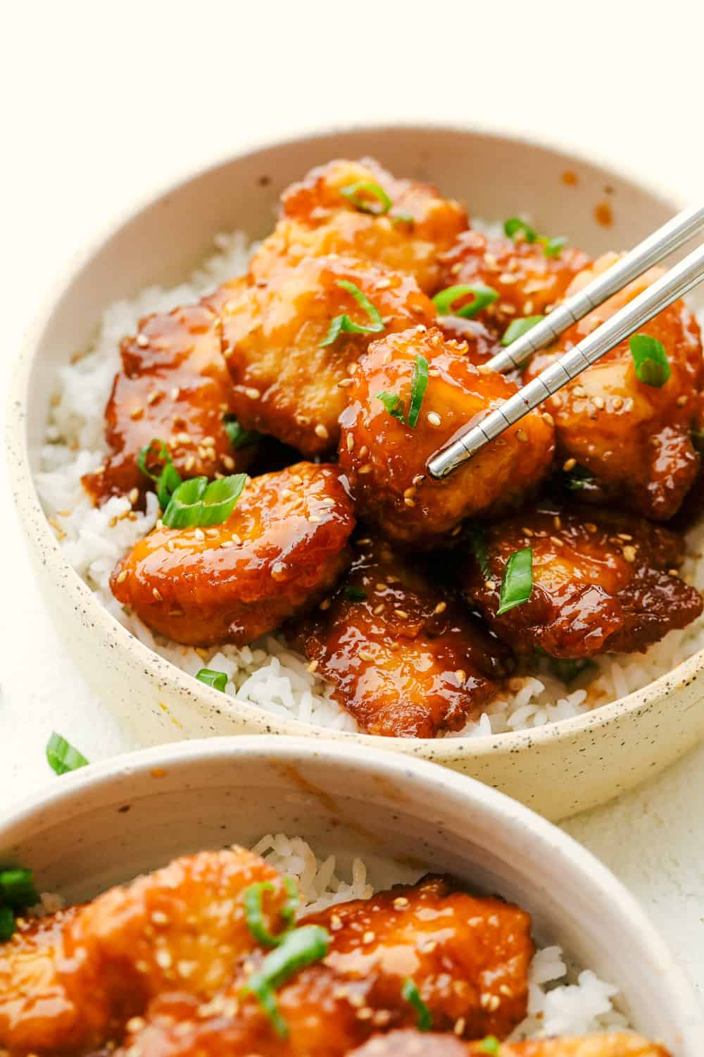 Baked Sweet and Sour Chicken is 1000x better than any takeout! It's crispy on the outside, juicy on the inside and exploding with flavor. There is a reason why this is our favorite recipe on the blog! Juicy, tender Baked Sweet and Sour Chicken on top of rice.