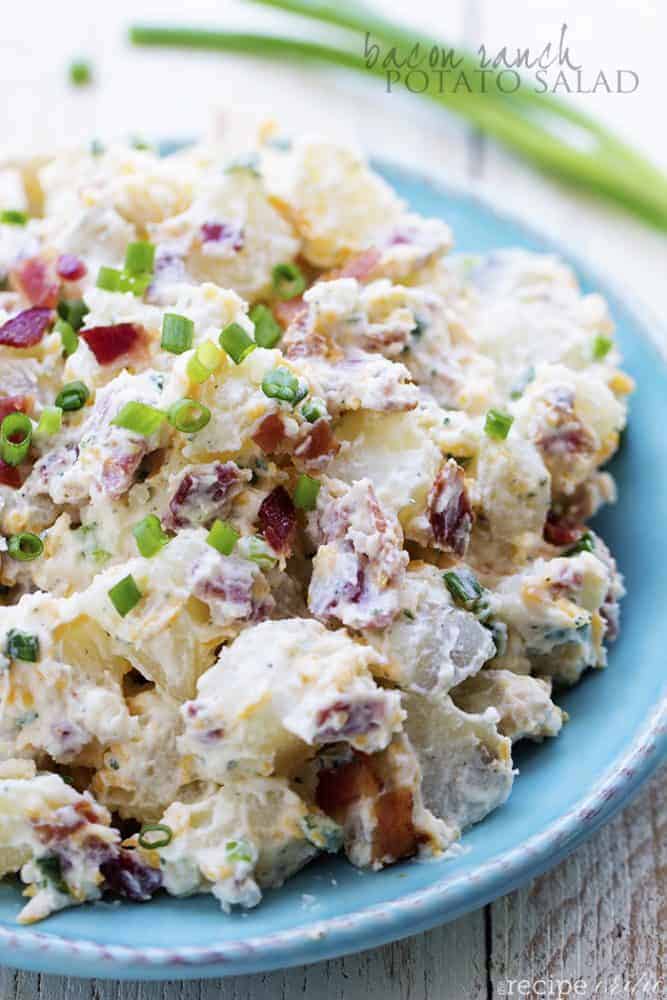 A creamy and delicious potato salad with amazing ranch flavor and bacon! This is the perfect side to take to a potluck and is sure to be a huge hit! bacon ranch potato salad on a blue plate.