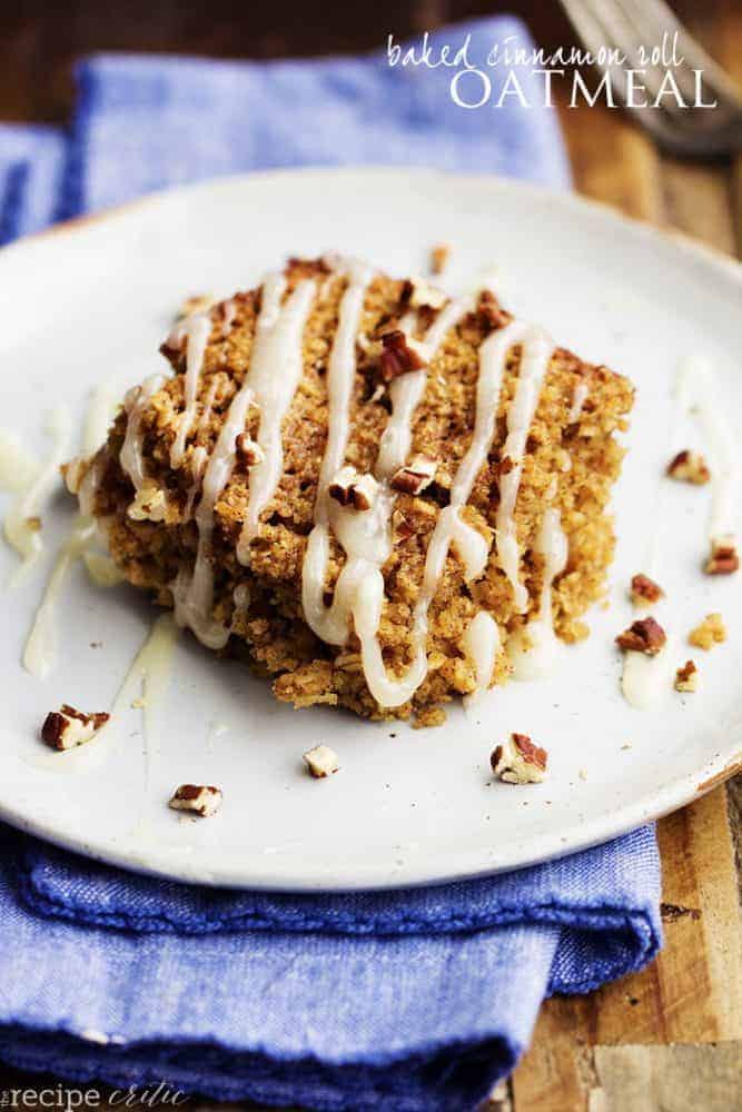 A quick and easy baked oatmeal with all of the goodness of a cinnamon roll inside. It is filled with brown sugar and cinnamon and topped with a cream cheese glaze. One of the best breakfasts you will make! baked cinnamon roll oatmeal on a white plate.