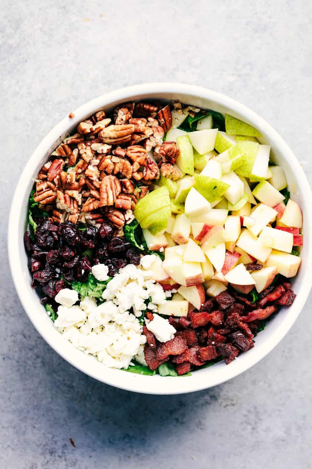 Autumn Chopped Salad with Creamy Poppyseed Dressing is all of your fall salad dreams come true! Crisp chopped apples, pears, romaine lettuce, crunchy pecans, bacon, cranberries and feta cheese combine in a creamy dressing to bring you one unforgettable salad! Autumn Chopped Salad with Creamy Poppyseed Dressing in bowl,