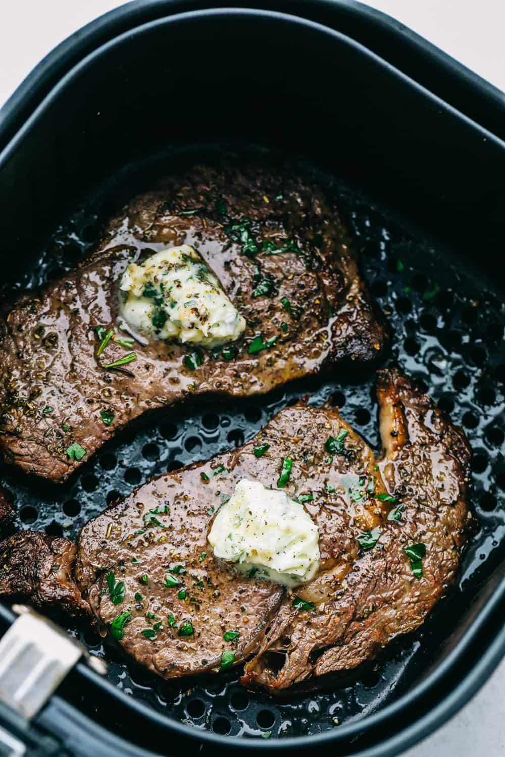 My Air Fryer Steak is a favorite around here for a reason! It’s perfectly seared, super juicy, and so full of flavor—it’s my go-to way to make steak! Perfect Air Fryer Steak with golden seared outside and tender juicy inside. Topped with garlic butter.