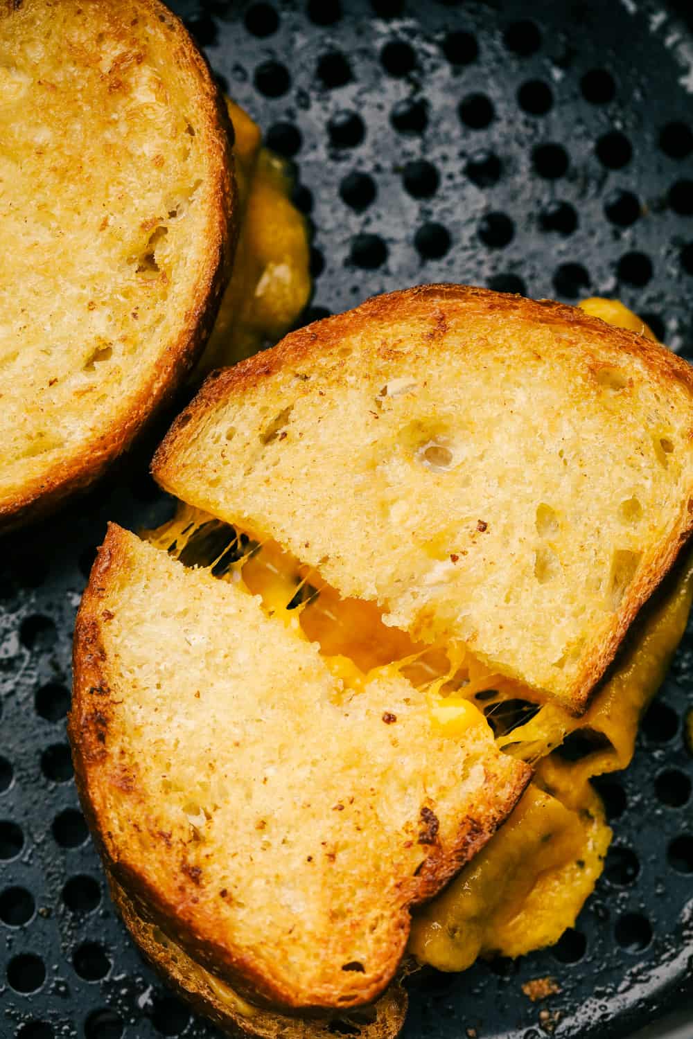 I want to introduce you to Air Fryer Grilled Cheese, the best I have ever had! Perfectly grilled to a crunchy golden brown on the outside and melty goodness on the inside. It's life changing. Grilled cheese in the air fryer.