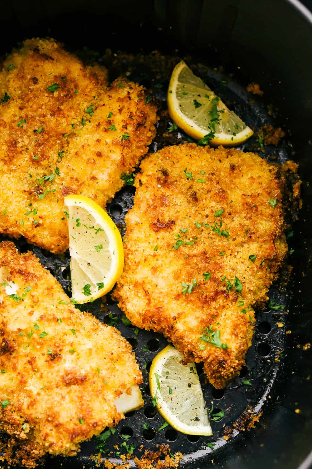 Air Fryer Cod will change the way you eat fish! Crispy golden outside and flakey tender inside, you are going to love this! Cooked cod in the air fryer with wedges of lemon.